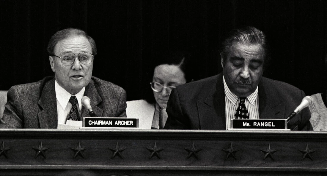 Congressman Bill Archer, seated next to fellow former Congressman Charles Rangel, speaks in his role as Chairman of the Ways and Means Committee.