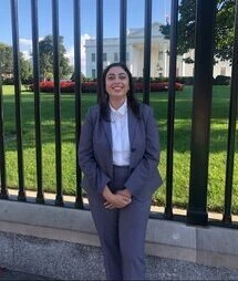 Jasmine Kaur stands in front of the White House grounds.