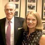 Elizabeth and James Bayless stand smiling together.